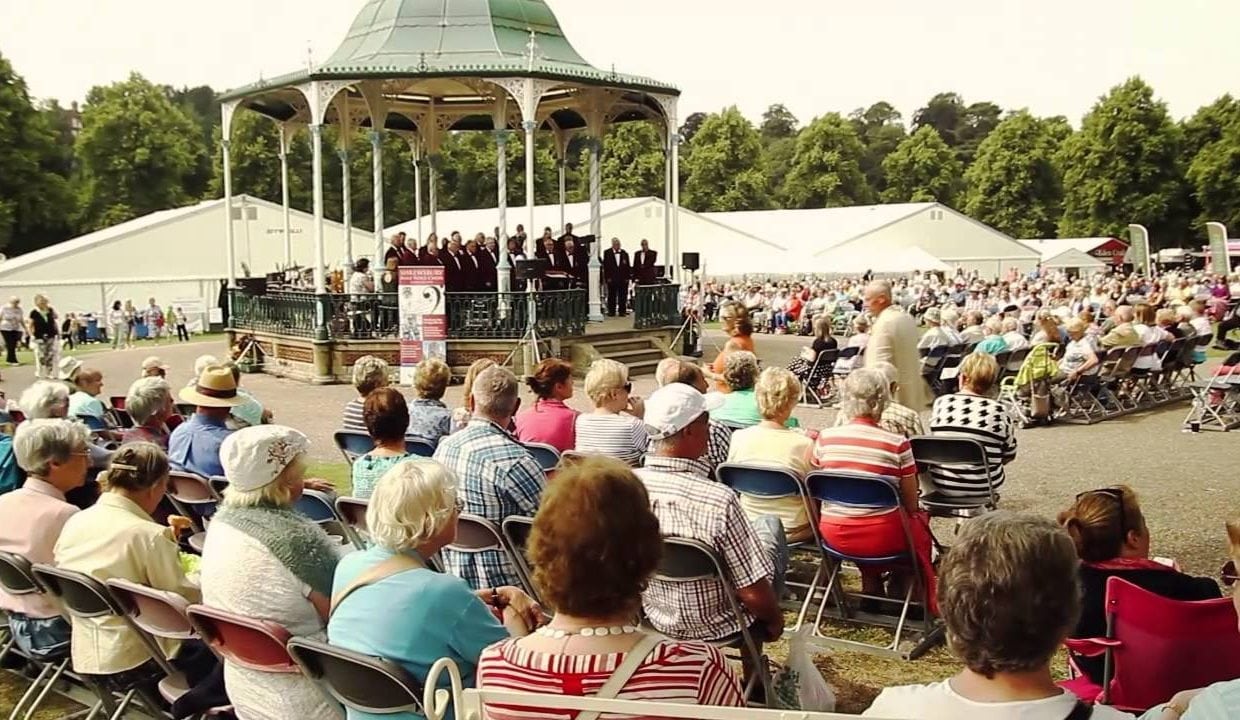 Shrewsbury Flower Show people sat around bandstand