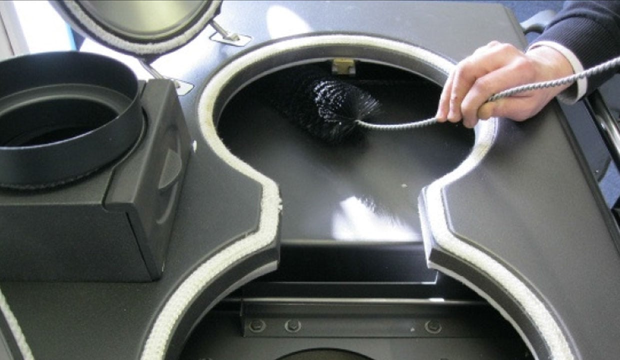 cleaning your cooker with flue brush