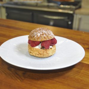 Choux buns with white chocolate ganache, raspberry and salted pistachio